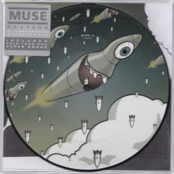 The image is of a vinyl record design for Muse's single Reapers. The artwork features cartoonish missiles or drones with large eyes and menacing grins against a cloudy sky backdrop.