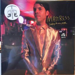 The image is the album cover for Mattress - Looking for My People. The cover features a photograph of a man wearing a shiny, metallic-looking suit, standing in what appears to be a dimly lit room with neon lights in the background. The album title, "Looking for My People," is written in a simple, handwritten-style font next to the artist's name "Mattress."
