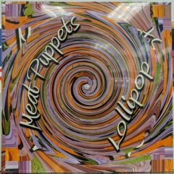 This image is the album cover of "Lollipop" by the Meat Puppets. It features a spiral design in a blend of swirling colours (orange, purple, green, and others), with the album title "Lollipop" and the band name "Meat Puppets" written in a slanted, artistic font around the spiral.