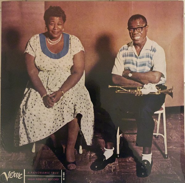 The album cover features jazz legends Ella Fitzgerald and Louis Armstrong seated together. Ella is dressed in a light-colored floral dress, smiling softly, while Louis, holding his trumpet, beams broadly in a striped shirt and black trousers.