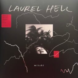 The album cover for "Laurel Hell" by Mitski features a dark background with white, abstract line patterns. In the center, there is a black-and-white photo of Mitski lying down with her hair spread out. The album title, "Laurel Hell," is written in a chalk-like font at the top, while the artist's name, "mitski," is printed in small white letters at the bottom.