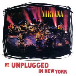 The image is the album cover for "Unplugged in New York" by Nirvana. It shows the band performing live on stage, surrounded by candles, flowers, and dim lighting. The word "Nirvana" is displayed at the top in bright yellow, while the album title "Unplugged in New York" is written at the bottom in red capital letters.