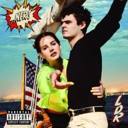 The album cover features a pop-art inspired design with a comic book-style speech bubble that reads "NFR!" in bold letters. Lana Del Rey is in the foreground, wearing a neon green jacket. A man stands behind her with his arm outstretched, guiding her as they stand on a boat with an American flag in the background. The ocean and sky form the backdrop. The letters "LDR" are in the bottom right corner, with a "Parental Advisory" label in the lower left.