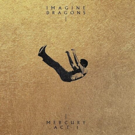 The album cover for Mercury - Act 1 by Imagine Dragons features a minimalist design with a gold-textured background. A small, dark silhouette of a person is seen falling or floating in the center, creating a striking contrast against the bright backdrop. The band's name "IMAGINE DRAGONS" is written in an elegant, uppercase font at the top, and the album title "MERCURY ACT 1" is placed at the bottom, separated by a thin vertical line.