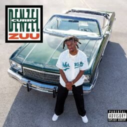 The cover features Denzel Curry standing confidently in front of a vintage green convertible. He's wearing a white Marlins jersey, black pants, and white sneakers. The bold text "DENZEL CURRY ZUU" is placed in the top left corner with a striking design.