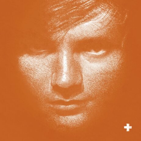 This is the album cover for Ed Sheeran - + (White Vinyl). It features Ed Sheerans face in white against an orange background.